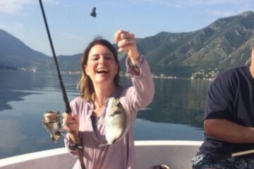 fishing adventure - a hero image of a smiling woman with her catch