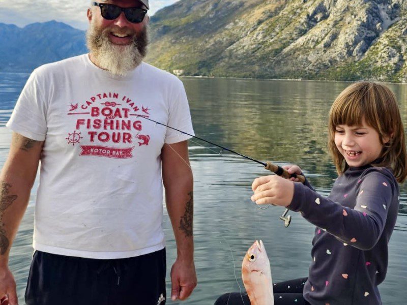 first big catch - HERO image of ivan and his daughter holding her first big fish