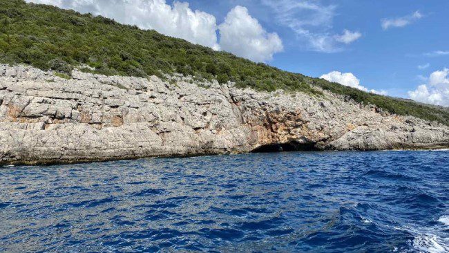 A very low cleavage entrance to the Blue Cave