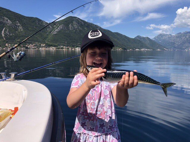 fishing for kids - Lara with her first mackerel laughing and giggling