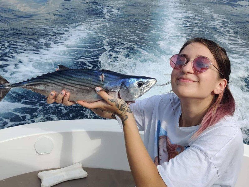 Kotor fishing charter - a girl posing with her catch, an atlantic bonito