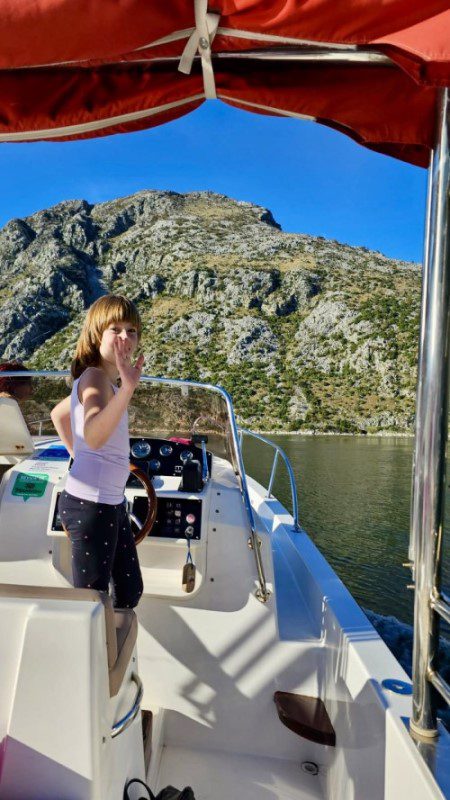 first big catch - Lara steering the boat