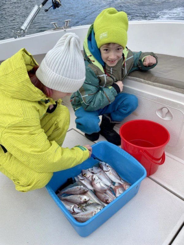 Kotor Fishing Charter - two kids with a bucket full of freshly caught fish