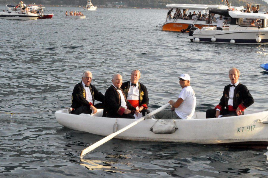 Fasinada Perast - view of an adorned vessel with partecipants singing