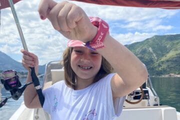 marine life conservation partnership: Lara holding a red snapper on a string (red snapper can't be seen) Hero image