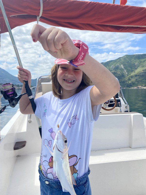 marine life conservation partnership: lara with red snapper on a string